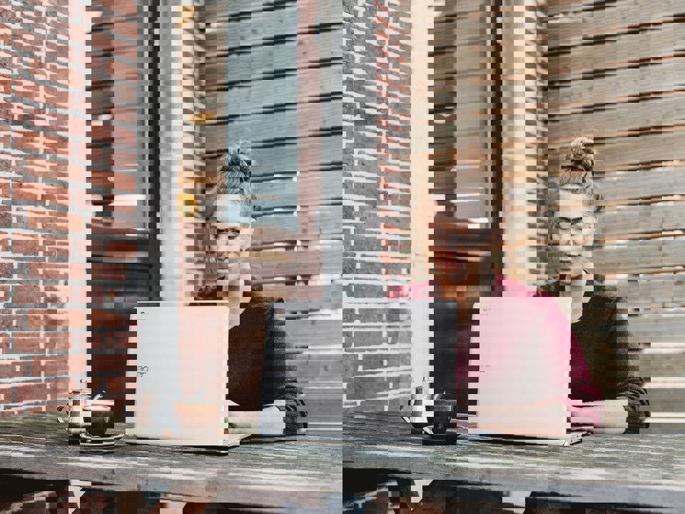 Woman working outside on a laptop