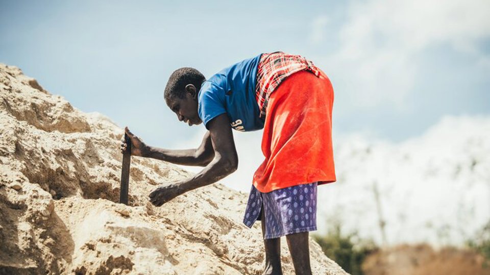 A quarry scavenger woman searching for rocks