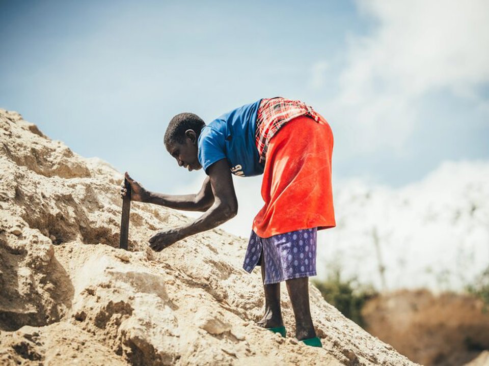 A quarry scavenger woman searching for rocks