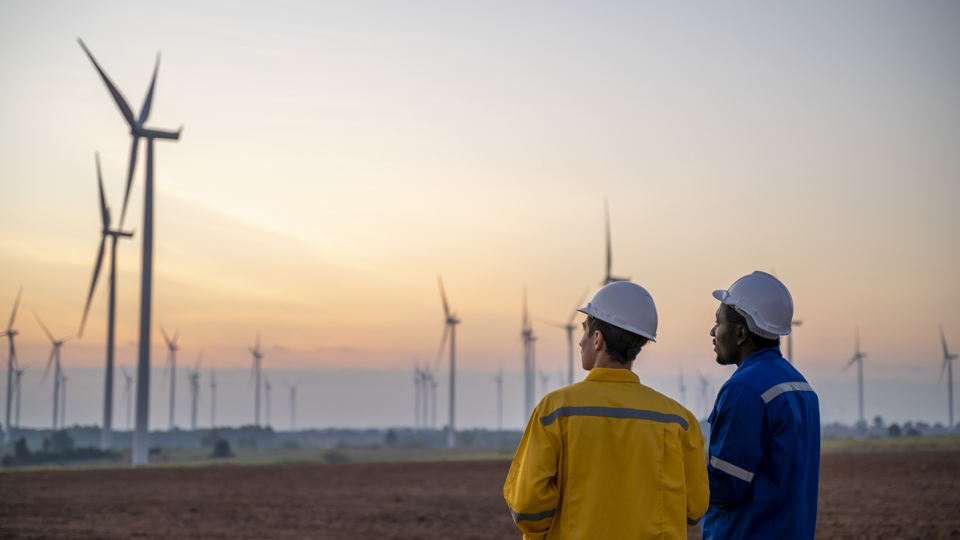 Two workers at a wind farm