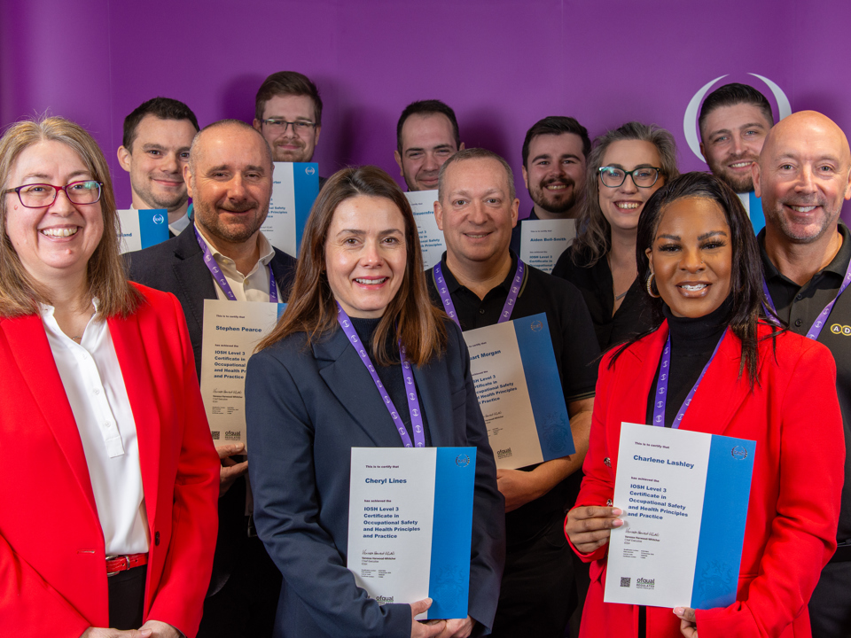 Four members celebrate completing an IOSH qualification 