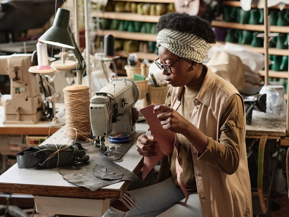 Textile worker using sewing machine