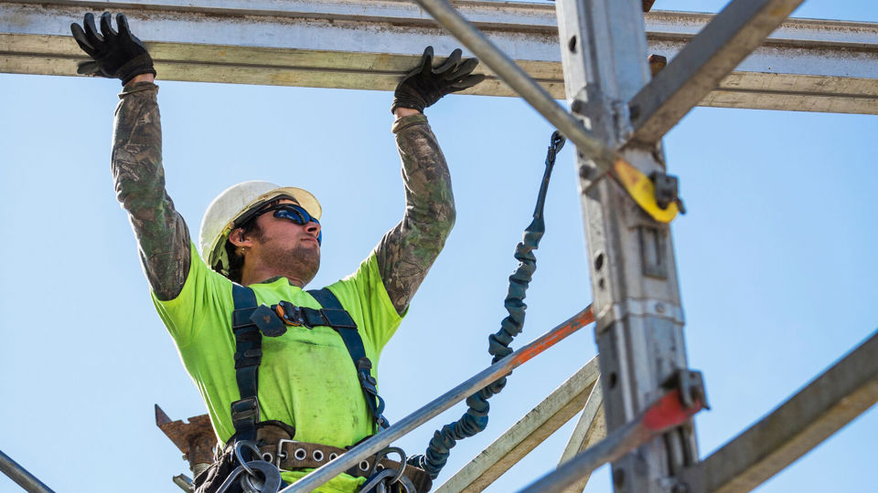 Scaffolding worker wearing high-vis jacket and helmet
