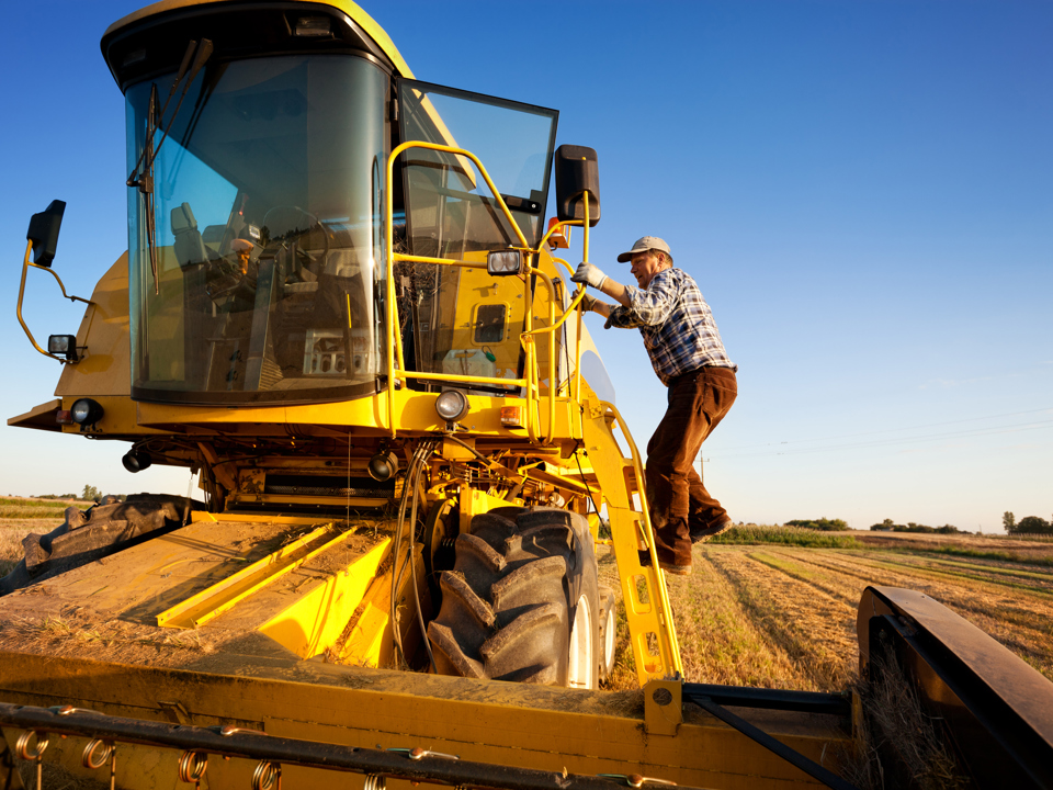 Farmer entering combine harvester