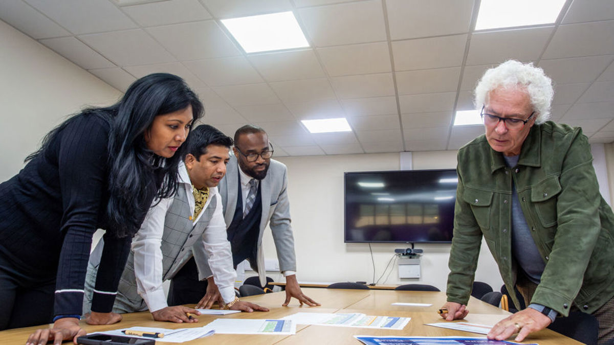 Volunteers around a table problem solving