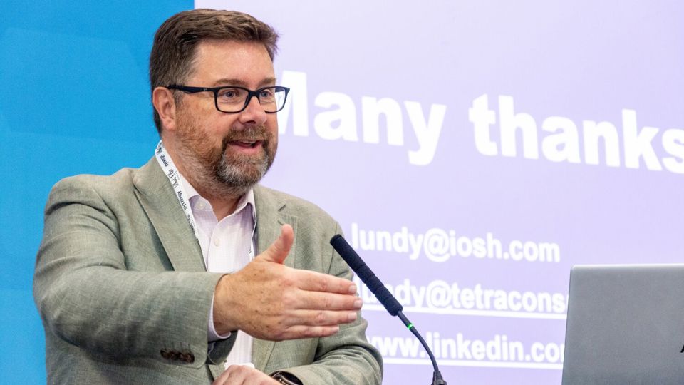 IOSH President-Elect Shaun Lundy speaking on stage at a conference