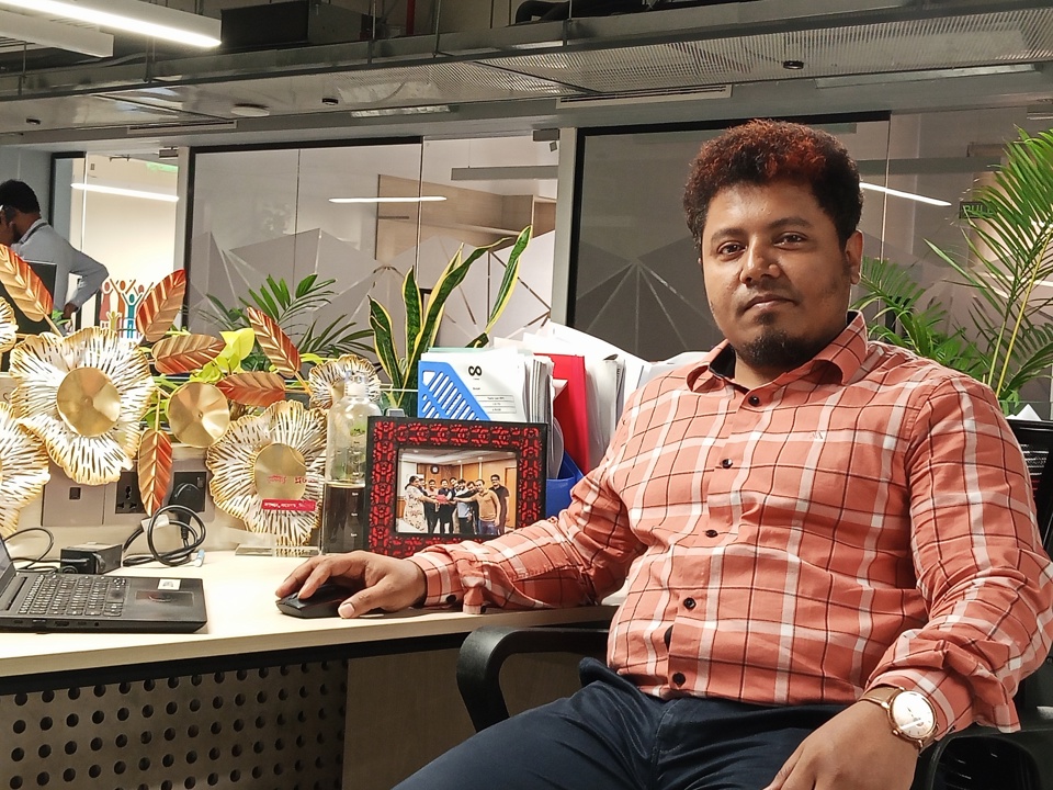 IQBAL MAHMUD FOYSAL sitting in an office, at a desk