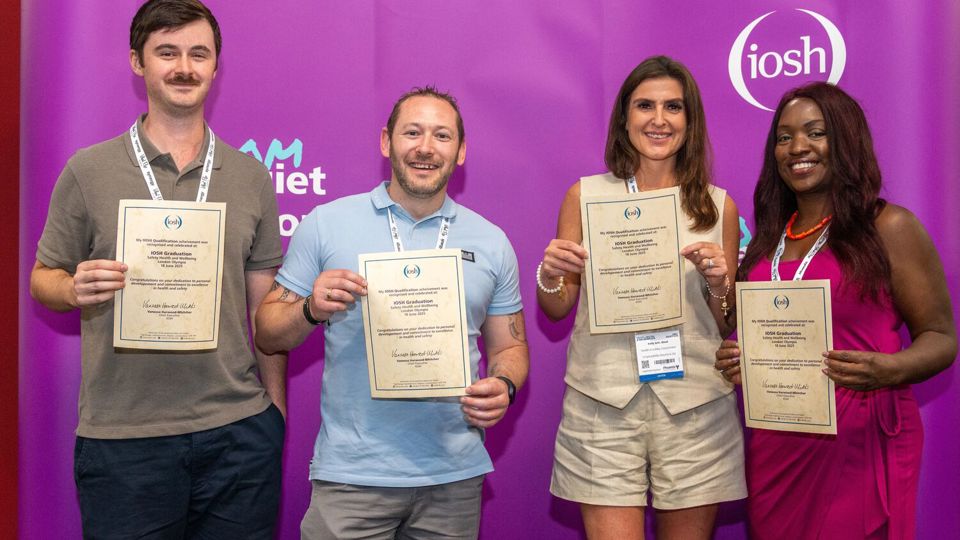 Four health and safety students with their IOSH qualification certificates