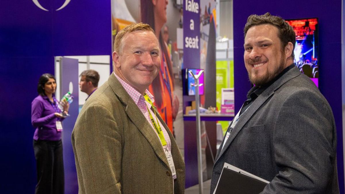Volunteers smiling at camera with IOSH logo in background